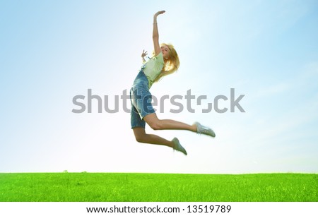 happy beauty young woman jump in field with green grass
