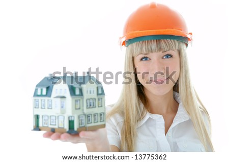 architect woman in helmet with little house on hand over white background