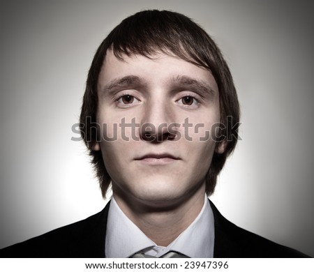 face of businessman from wide angle lens on gray background