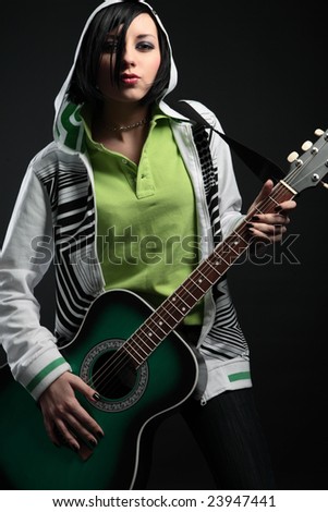 young emo girl with guitar on black background
