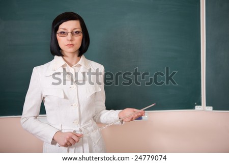 young teacher woman on green board in classroom
