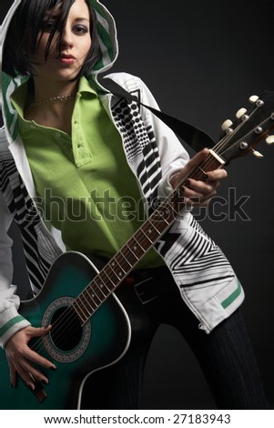 emo girl with guitar on black background