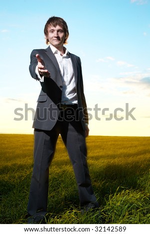 young  business man help hand in field