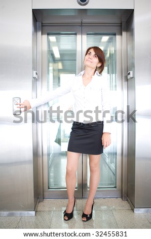 business woman push button of  elevator