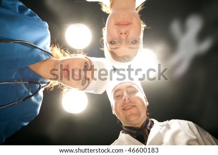 three doctor on operations with white lamp