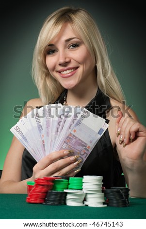 Poker player in casino with cards and chips on green background