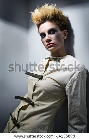 scary zombie girl in gray room in mental hospital
