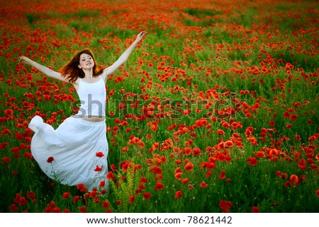 beauty woman in white dress running poppy field