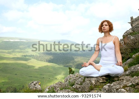 woman training yoga on beauty landscape