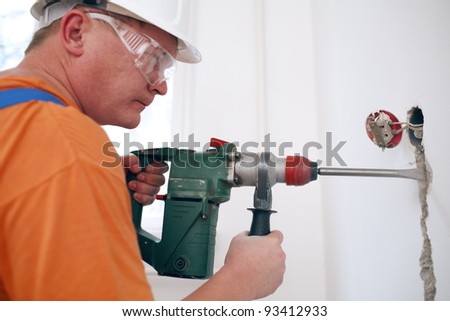 worker makes repairs in the apartment