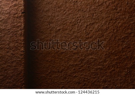Dark brown terracotta texture closeup (design element)