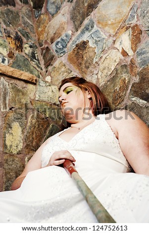 A plus size bride trashes her wedding dress with green paint