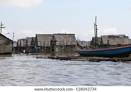 Houses on stilts rise above the polluted water in Belen, Iquitos, Peru. Thousands of people live here in extreme poverty without clean water or sanitation.