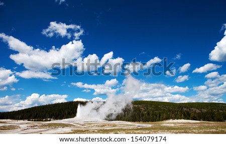 A geyser in Yellowstone National Park begins to erupt