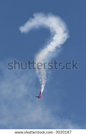 A stunt airplane performs a dive and appears to draw a question mark in the sky with smoke