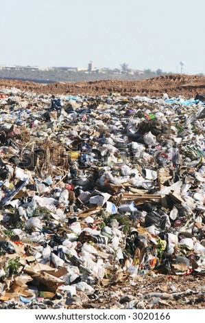 A giant mound of trash in a landfill. All trademarks and logos digitally removed.