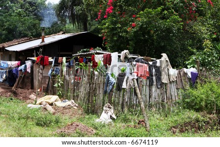 A rural home hangs it's laundry to dry on the fence