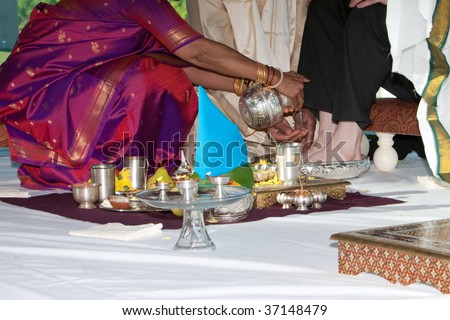 A groom has his feet washed during a traditional Hindu Indian wedding ceremony