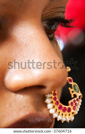 A closeup of the face and nose ring of a young Indian brde