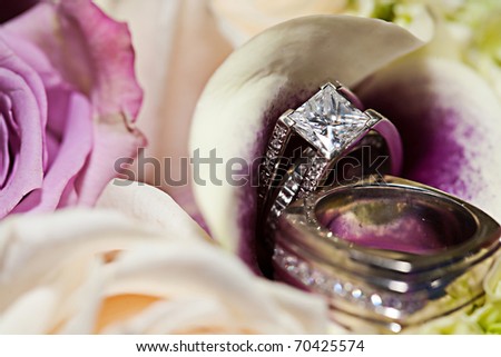 stock photo Diamond wedding bands on a floral background