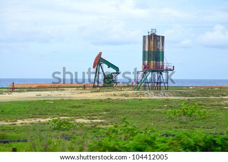 The view of the oil pump on the sea beach