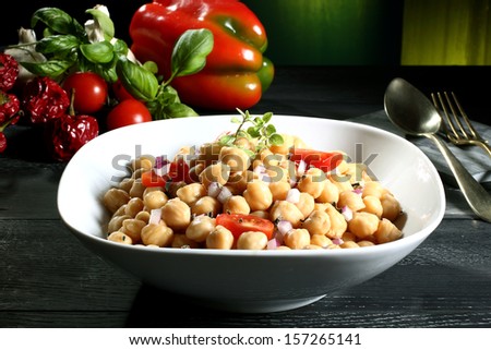 chickpeas salad in white bowl green background