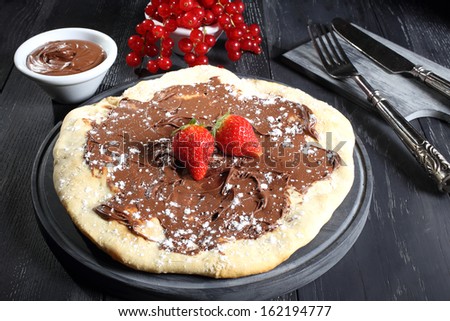italian pizza with chocolate and berries gray background