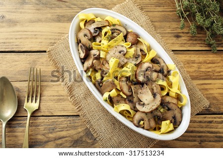 slow food  pasta with mushrooms rustic table background