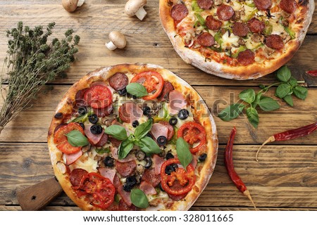 top view pizza with ham pepperoni and tomato slice on rustic table