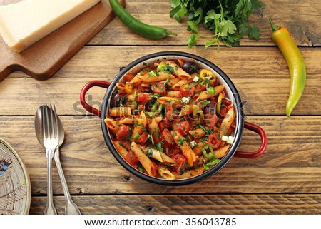 italian pasta with sausages in sauce tomato rustic table background