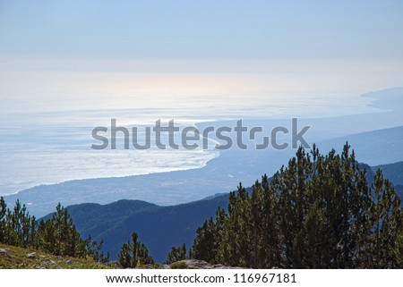 Deep blue sea viewed from great distance from high mountain