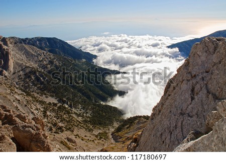 High mountain with clouds and sea in the distance
