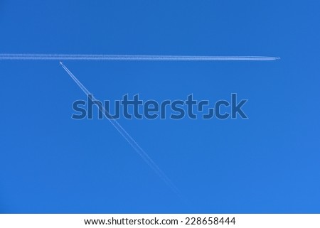 Vapor trail- A plane flying on a perfectly blue sky
