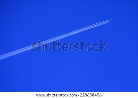 Vapor trail- A plane flying on a perfectly blue sky