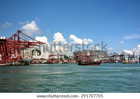 HONG KONG -June 16,2015 : Gantry crane and containers at Hong Kong commercial port. Port of Hong Kong is one of the busiest ports in the world.