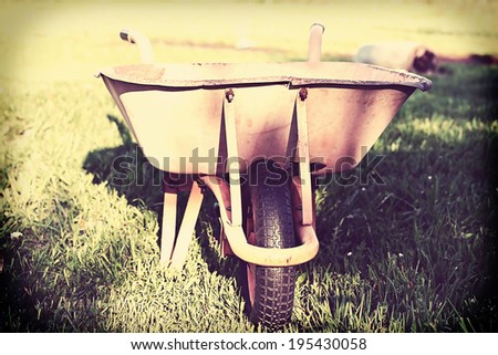Old rusty wheelbarrow, retro photo filter effect