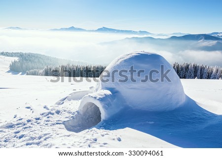 Marvelous huge white snowy hut, igloo  the house of isolated tourist is standing on high mountain far away from the human eye