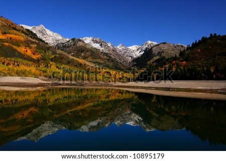High mountain lake in the fall showing autumn colors reflected in the water