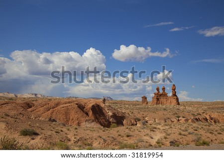 View of red rock formations in San Rafael Swell with blue sky?s the and clouds