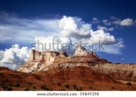 View of red rock formations in San Rafael Swell with blue skyâ??s the and clouds