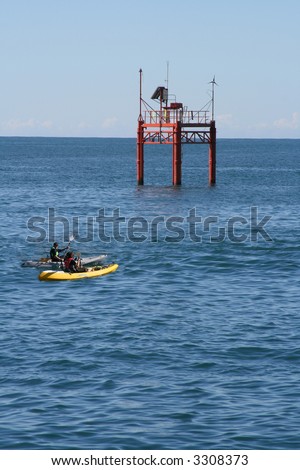 Kayaks near navigational equipment