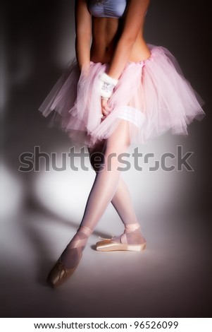 stock photo Beauty sexy ballerina in pointes on white studio background