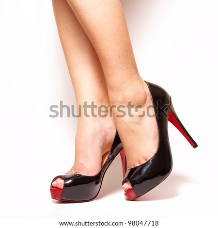 Sexy beauty long woman legs wearing fashion high heel shoes isolated on white studio background