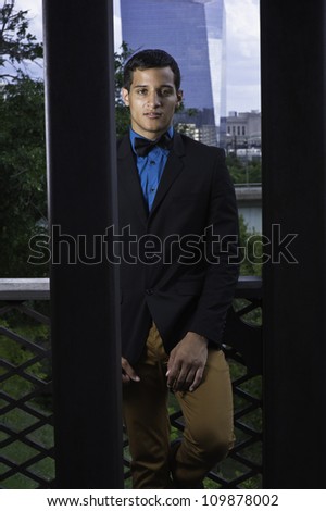 A young, professional service person is standing near by. Background is a modern business high building/Mister