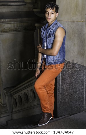A young attractive guy is standing by a stairs and into deeply thinking/Thinking Outside