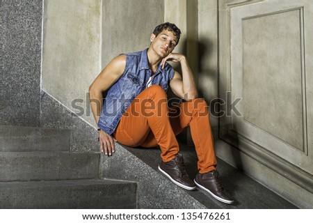 A young guy is sitting outside,  looking at you and thinking/Portrait of Young Guy