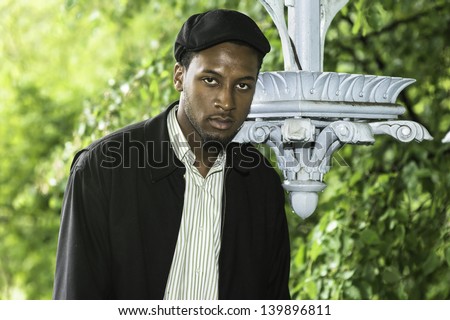 A young handsome guy is seriously looking at you./Portrait of Young Black Guy