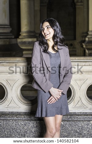 A young businesswoman is standing in hallway and laughing/Portrait of Businesswoman