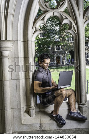Dressing in a gray polo shirt, pattern shorts and black leather sneakers, wearing glasses,  a young handsome scholar is sitting on a old fashion window frame and study on a computer. /Study by Window