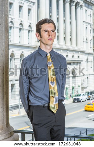 Dressing in a blue shirt, black pants, a colorful tie, hands putting in the back, a young college student is standing outside an office building, relaxing and thinking. / Portrait of College Student